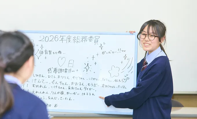 ホワイトボードの前で発表する生徒